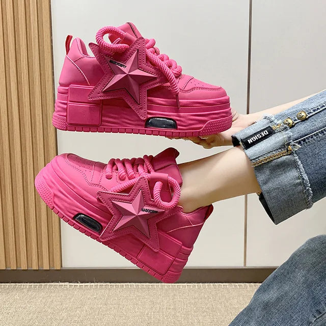 Stylish pink platform sneakers with star design, featuring lace-up closure and cushioned sole.