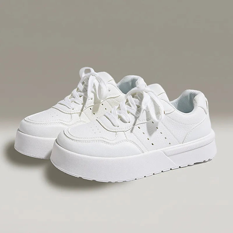 White platform sneakers with lace-up closure and breathable material for casual style.