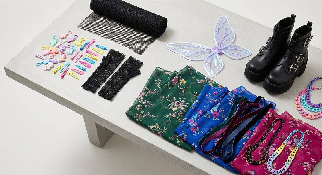 A bird's-eye flat-lay of eclectic Harajuku fashion accessories and clothing pieces representing multiple Japanese street style subcultures, including pastel charms, black lace, platform boots, and sheer floral fabrics.