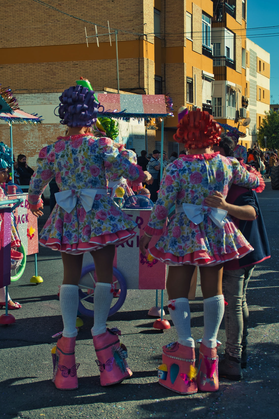 a couple of girls standing next to each other on a street