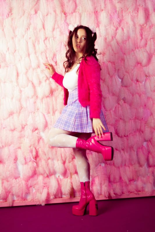 a woman in a short skirt and pink jacket