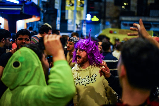 People are celebrating in the crowded street.