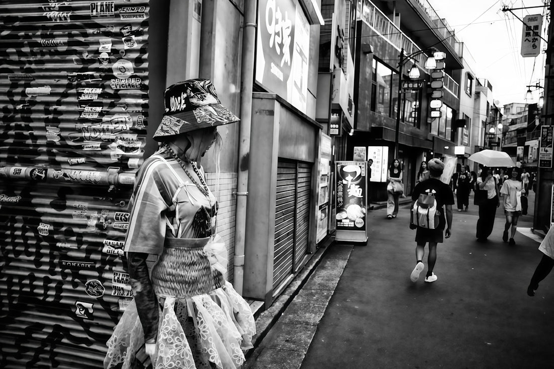 Woman in elaborate hat on a city street
