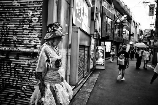 Woman in elaborate hat on a city street
