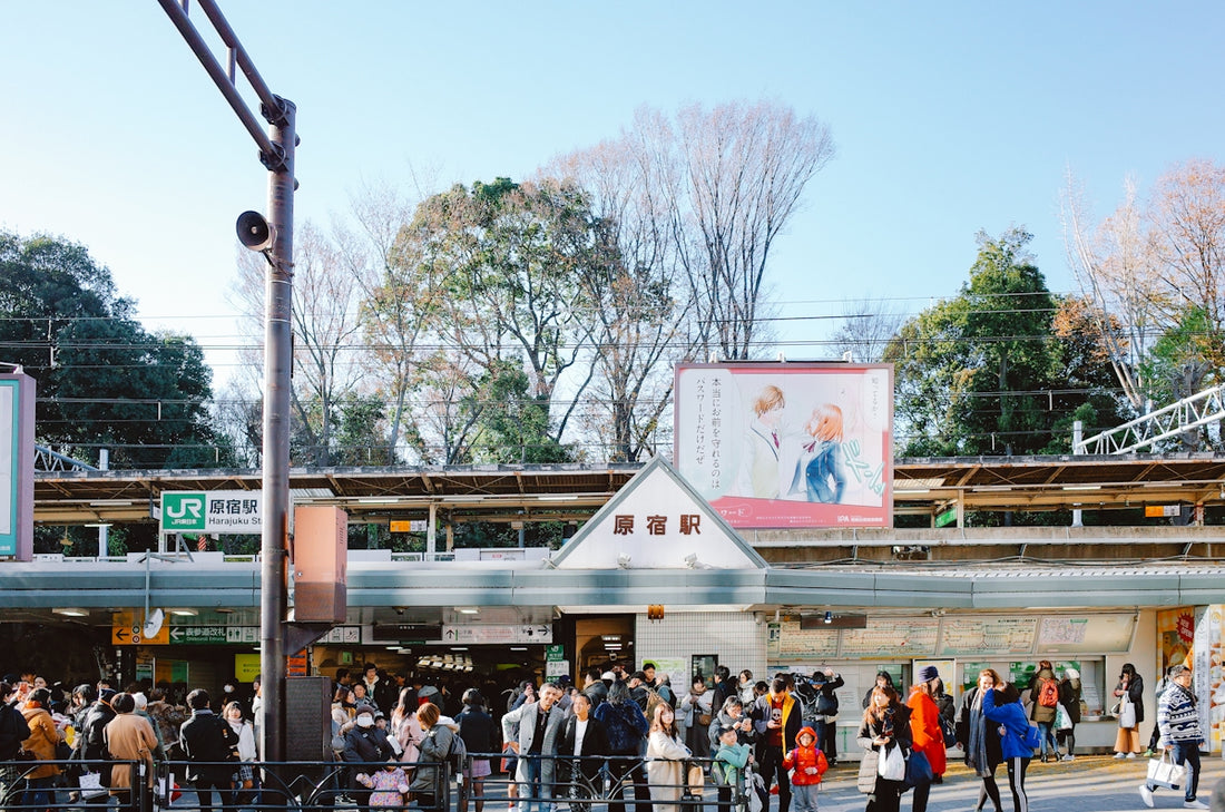 People gathered outside a busy train station entrance.