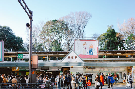 People gathered outside a busy train station entrance.
