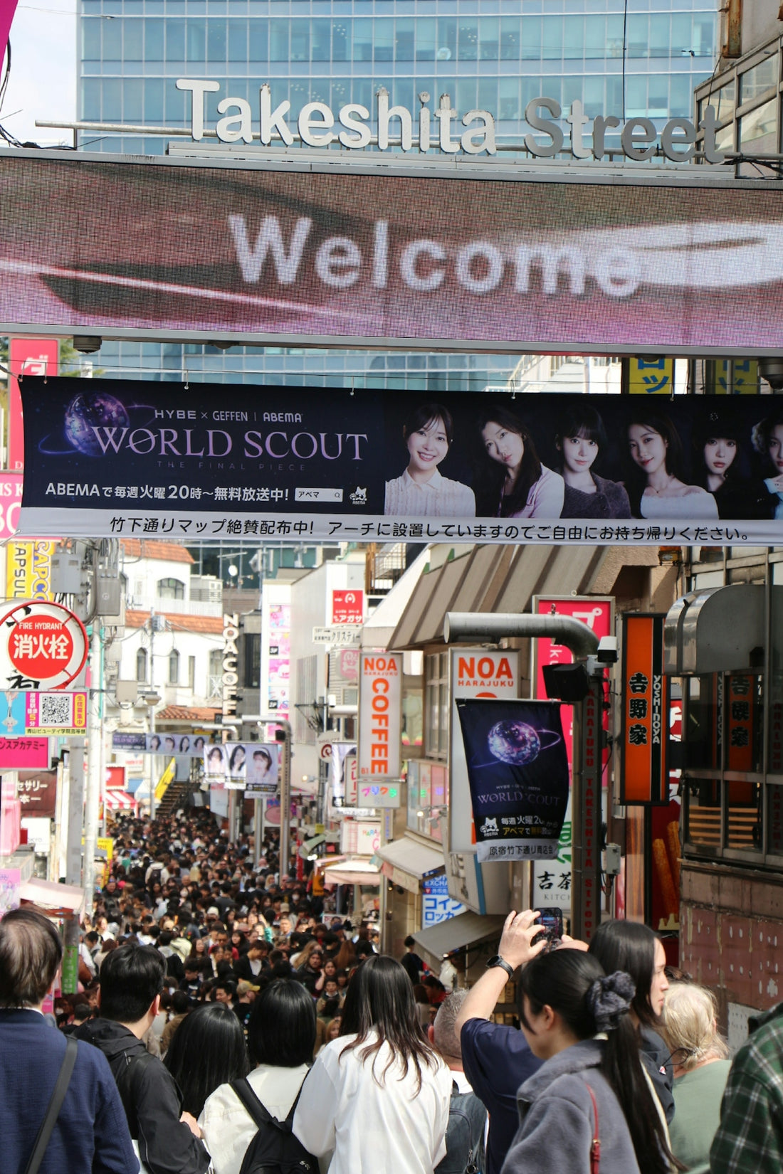 Crowded takeshita street in tokyo with shops and banners